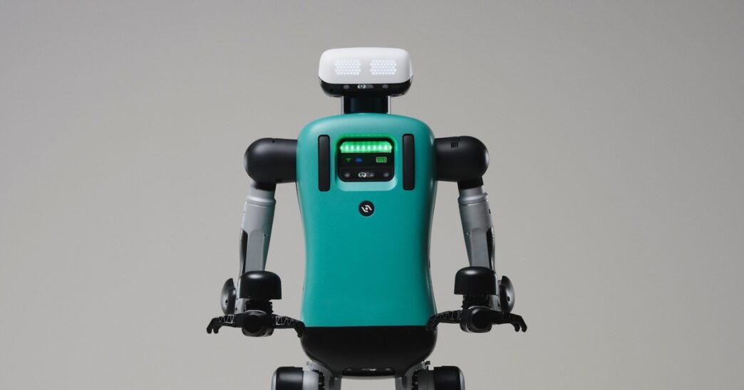 Agility Robotics Digit humanoid robot with a teal torso and white head unit, shown from the waist up against a plain grey studio background