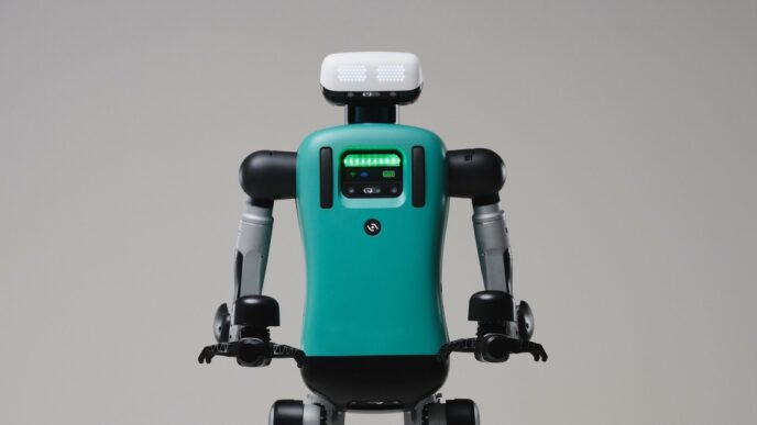 Agility Robotics Digit humanoid robot with a teal torso and white head unit, shown from the waist up against a plain grey studio background