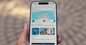 Hand holding a smartphone showing a ChatGPT answer with an interactive San Francisco route map and photo cards for Haight-Ashbury