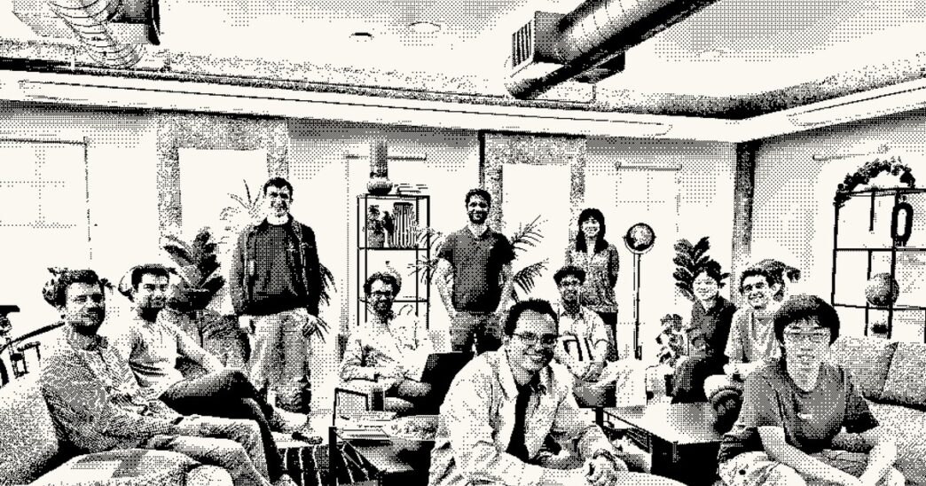 A dithered black-and-white group photo of about a dozen people sitting and standing in an office lounge, published on Inception's website
