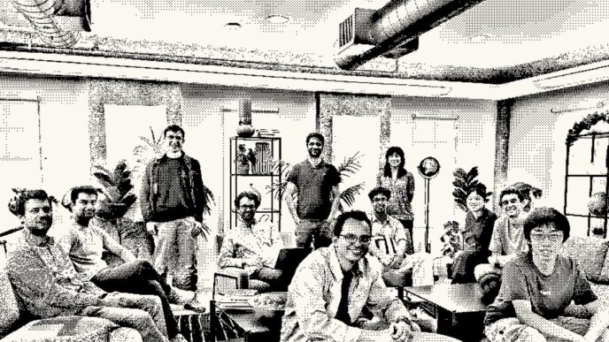 A dithered black-and-white group photo of about a dozen people sitting and standing in an office lounge, published on Inception's website