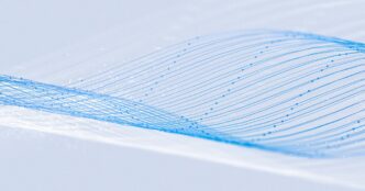 Soft abstract light-blue flowing lines on a textured white background, hero graphic from Meta's Muse Spark Open research blog