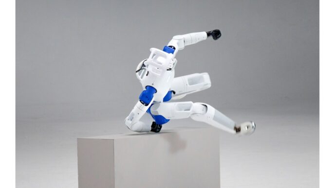 RoboParty RP1 white-and-blue humanoid robot vaulting over a gray pedestal in a studio, head and blue ROMOMO joint modules visible