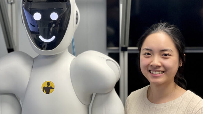 Halodi Robotics collaborative humanoid standing beside a perception engineer in a lab setting, both heads visible