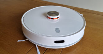 Top-down view of a white Xiaomi Lydsto robot vacuum and mop with a raised lidar turret, resting on a wooden floor