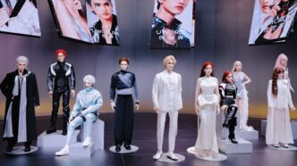 A row of lifelike UBTech UWORLD U1 humanoid robots in fashion outfits standing and sitting on display pedestals under UWORLD screens