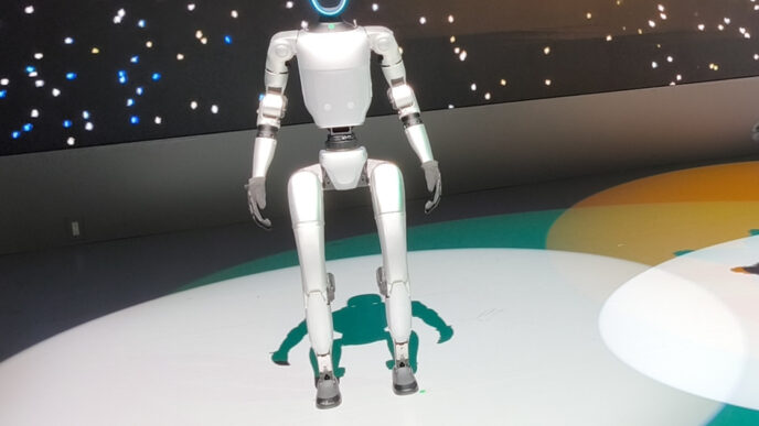 Unitree G1 humanoid robot standing on a lit circular stage at the Japan Mobility Show 2025