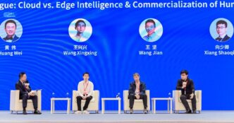 Four men in white armchairs on a stage at the 2026 China International Industry Fair, below a blue screen showing their photos and names: Huang Wei, Wang Xingxing, Wang Jian and Xiang Shaoqing